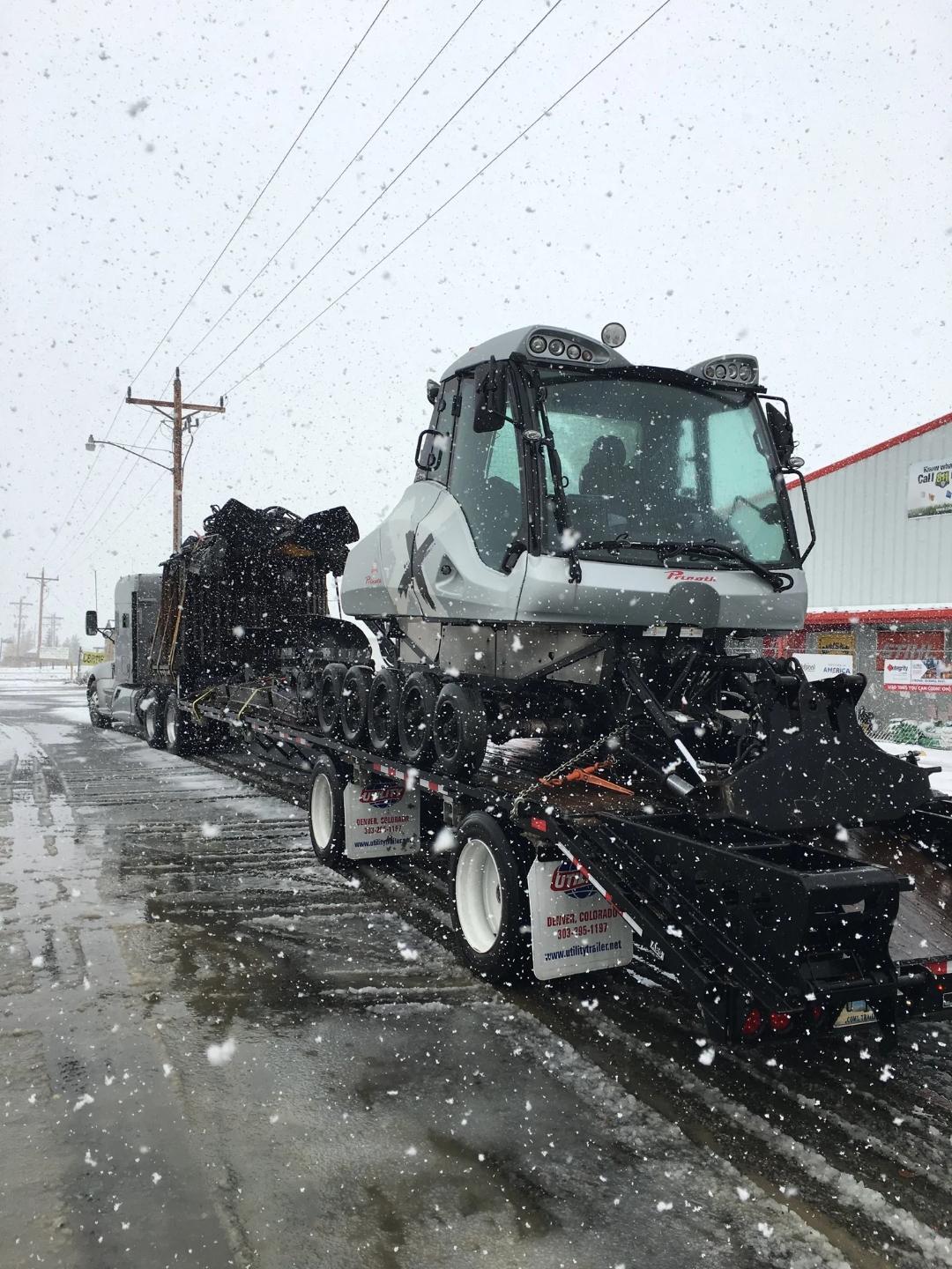 Prinoth snowcat loaded on a lowboy trailer for delivery in a Colorado snowstorm