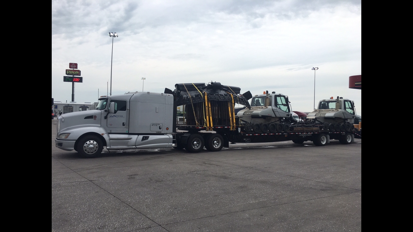 Mountain States Snowcats truck hauling multiple snowcats on a lowboy trailer